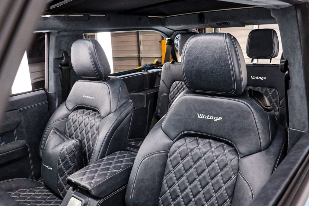 Luxurious black leather custom car seats with diamond stitching, labeled "Vintage," inside a vintage-modern vehicle interior. Perfect for a stylish, nostalgic automotive upgrade.
